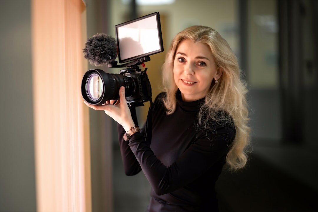 Finnish female camera operator portrait holding a broadcast camera